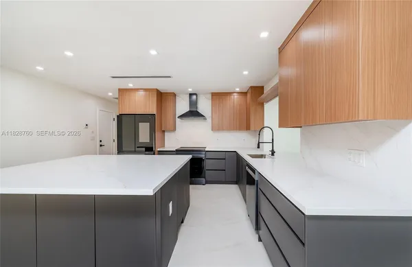 a kitchen with a sink a stove and cabinets