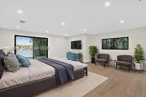 a bedroom with a large bed and a couch