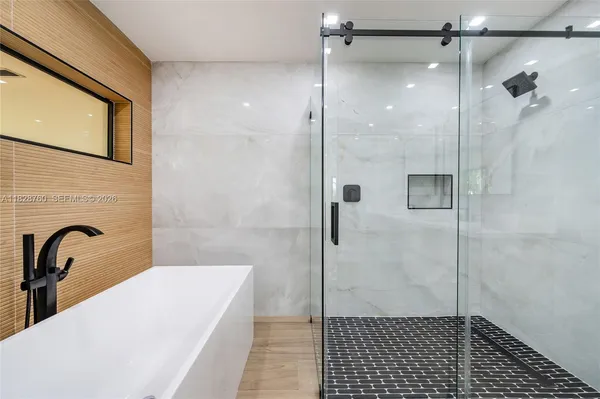 a bathroom with a granite countertop shower
