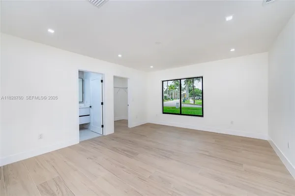 a view of an empty room with a window