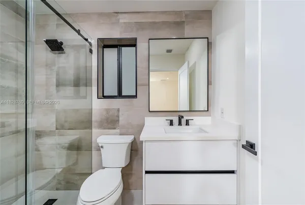 a bathroom with a sink toilet and shower