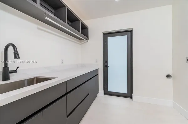 a kitchen with a refrigerator and a sink