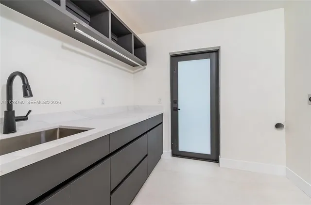 a kitchen with a refrigerator and a sink
