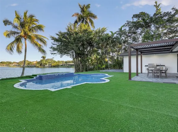 a view of a backyard with swimming pool