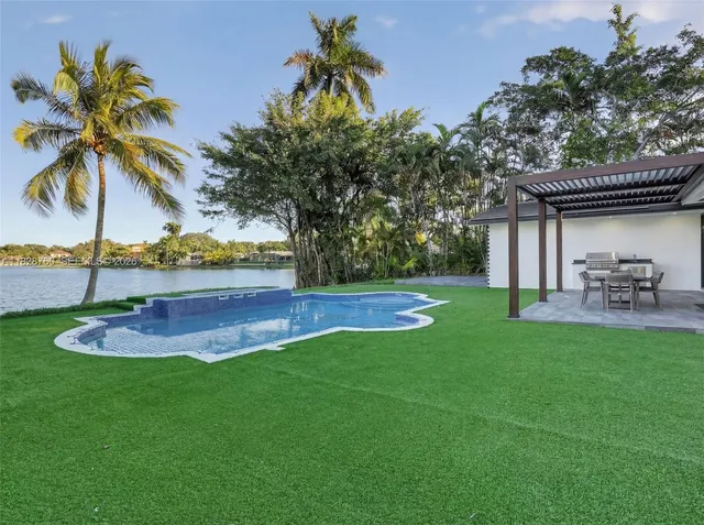a view of a backyard with swimming pool