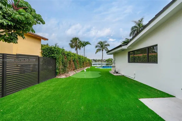 a backyard of a house with table and chairs