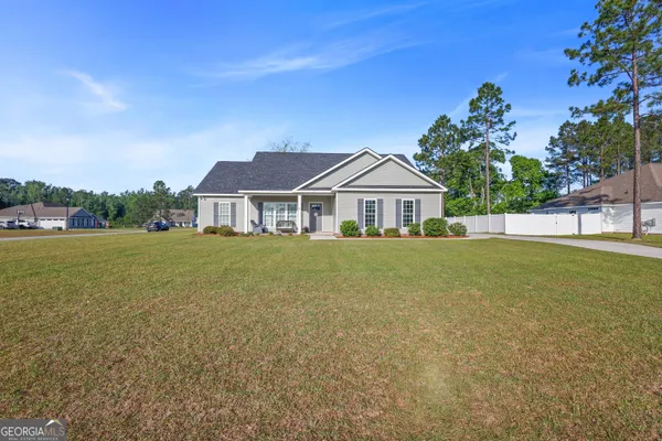 a front view of a house with garden