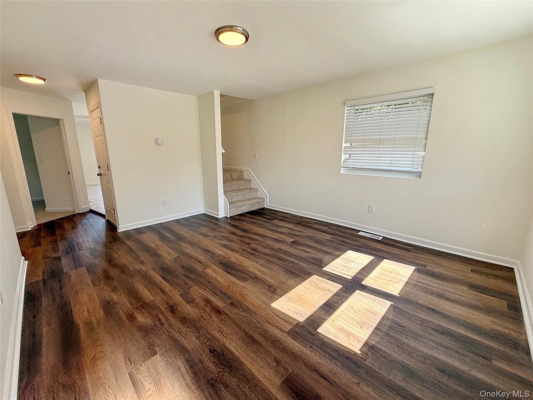 225 Fir Grove Road Ronkonkoma, NY 11779 - Photo 14 of 22 a view of an empty room and window