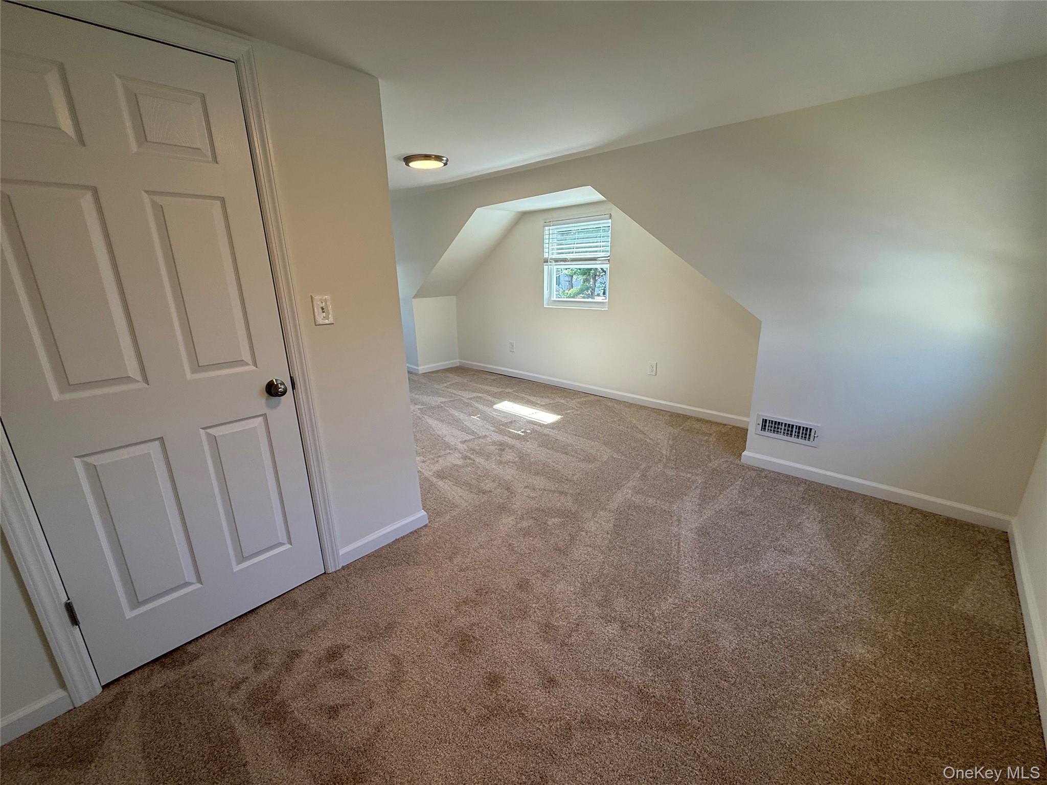 225 Fir Grove Road Ronkonkoma, NY 11779 - Photo 16 of 22 an empty room with windows