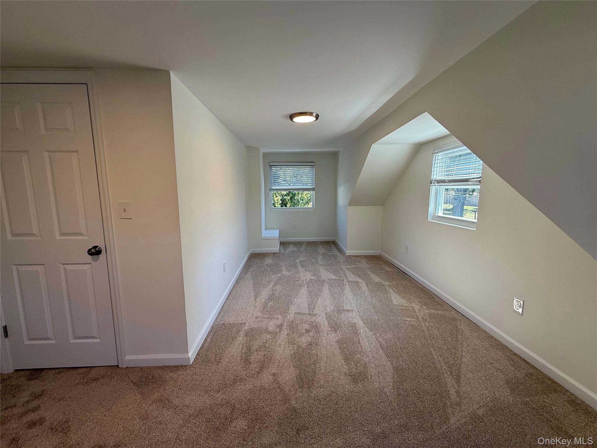 225 Fir Grove Road Ronkonkoma, NY 11779 - Photo 17 of 22 an empty room with windows