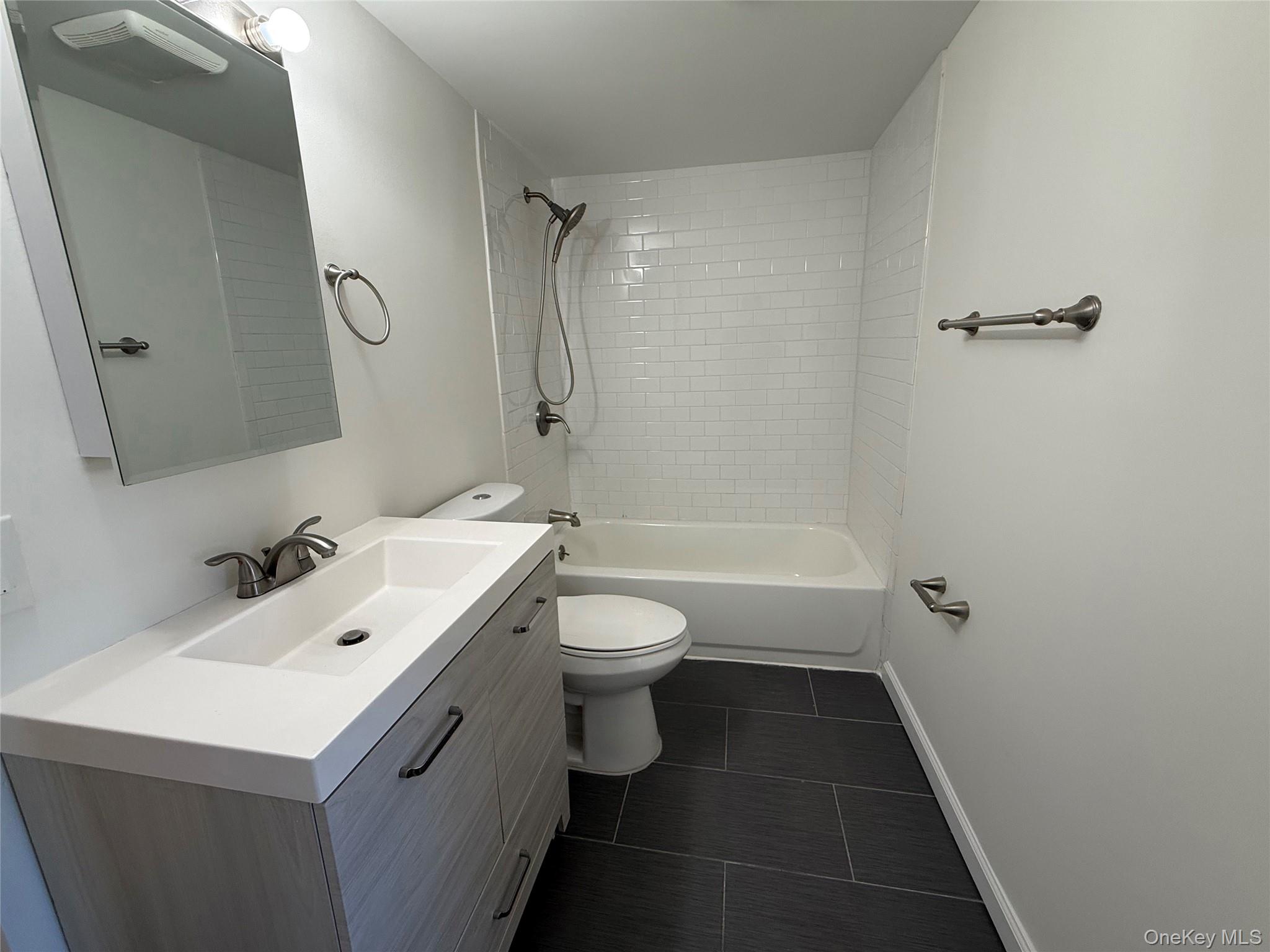 225 Fir Grove Road Ronkonkoma, NY 11779 - Photo 18 of 22 a bathroom with a sink a toilet and shower