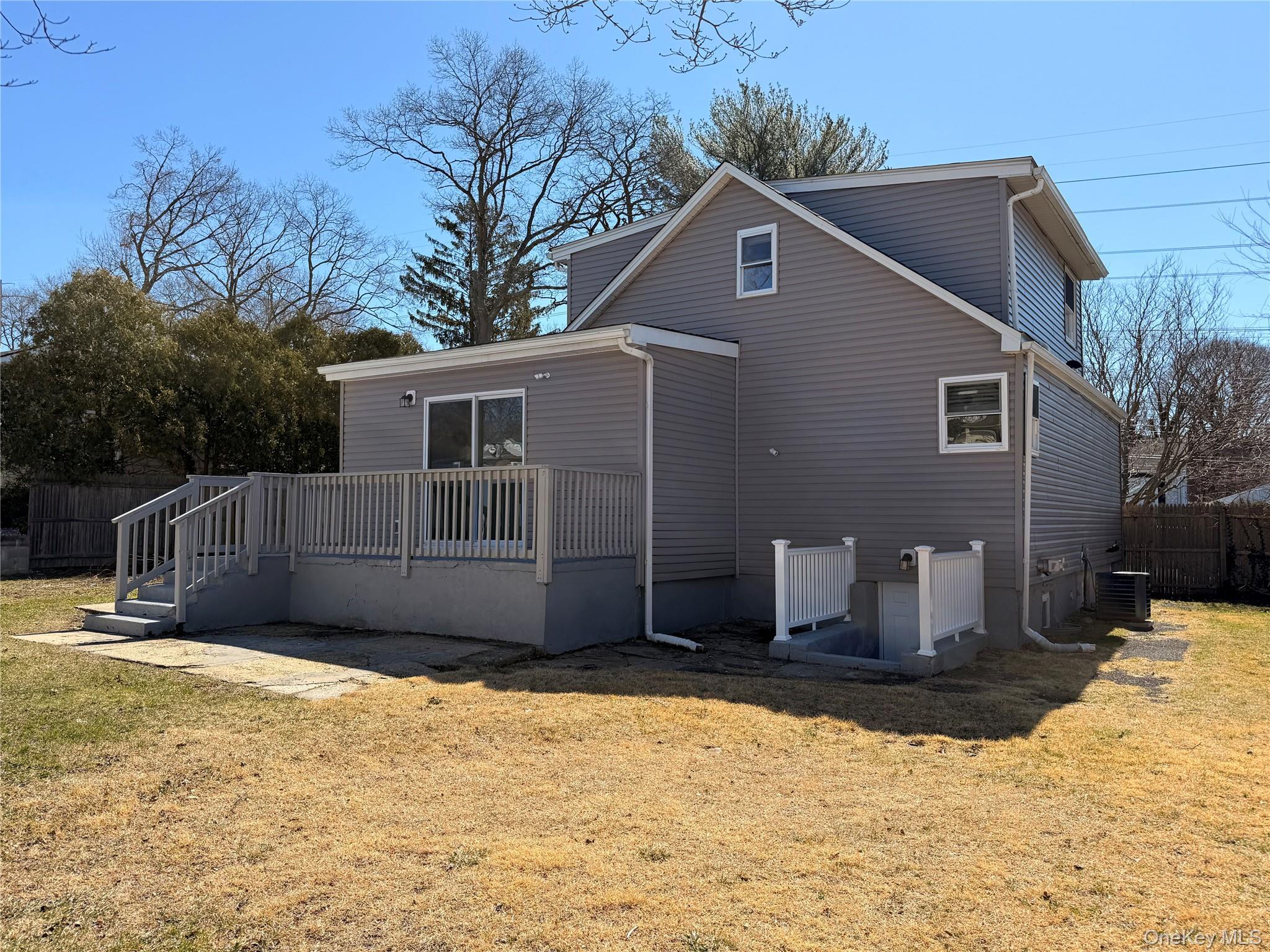 225 Fir Grove Road Ronkonkoma, NY 11779 - Photo 3 of 22 a front view of a house with a yard