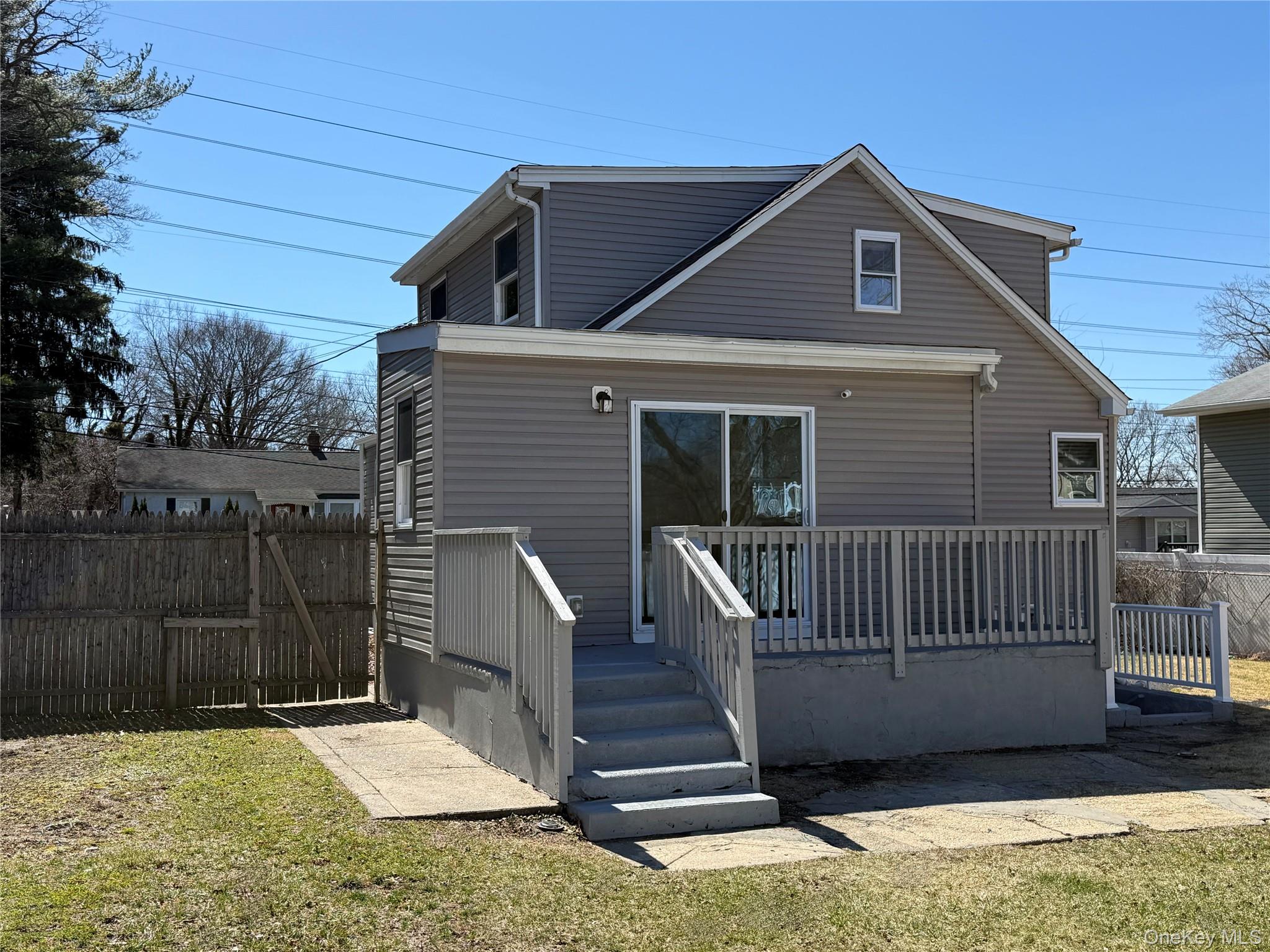 225 Fir Grove Road Ronkonkoma, NY 11779 - Photo 5 of 22 a view of a house with a yard and wooden fence