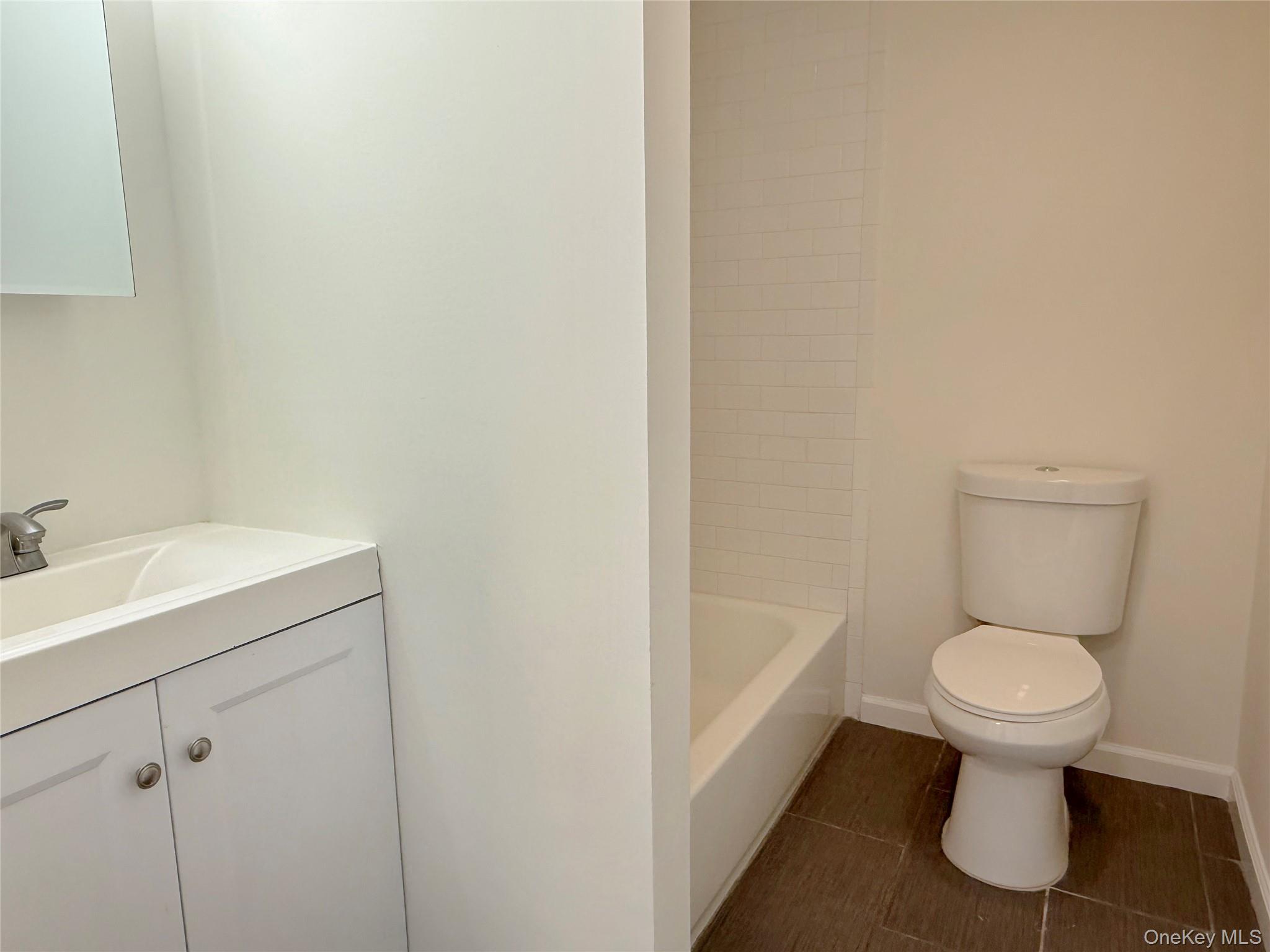 225 Fir Grove Road Ronkonkoma, NY 11779 - Photo 10 of 22 a bathroom with a sink toilet and a mirror