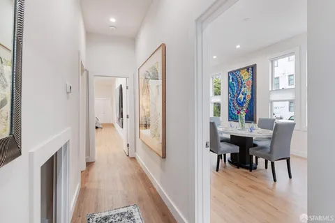 a view of a a dining room with furniture window and wooden floor