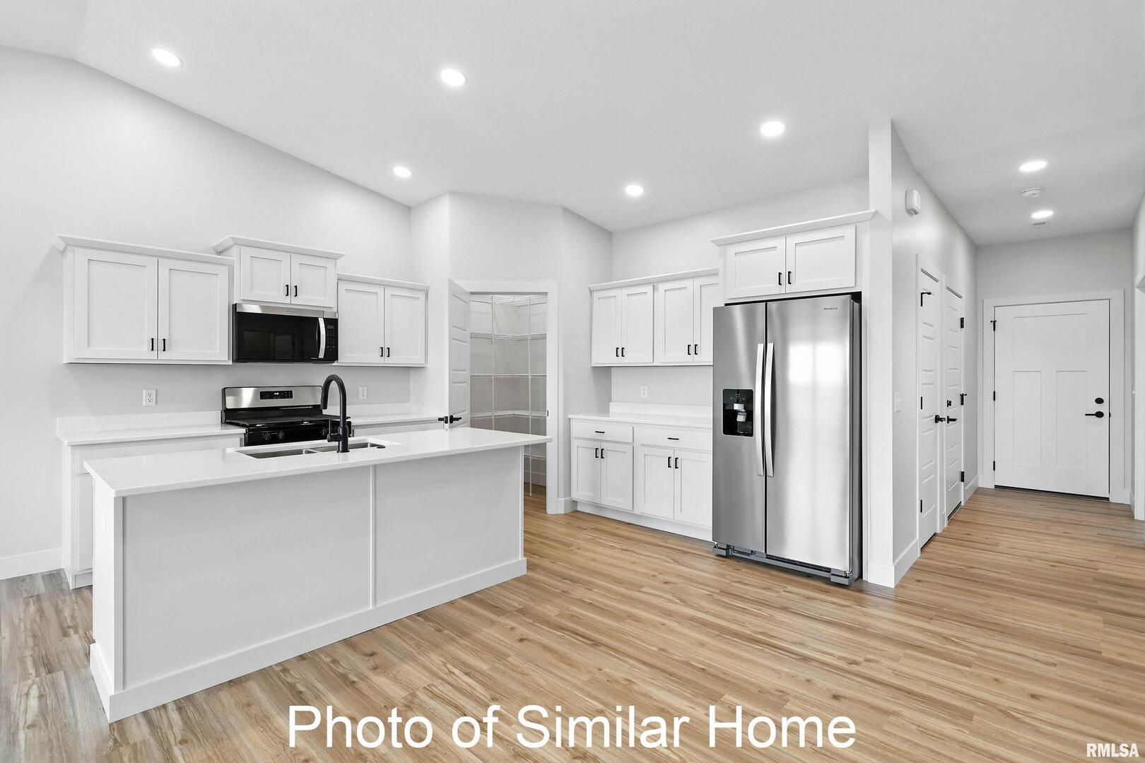 559 North 4th Avenue Eldridge, IA 52748 - Photo 13 of 31 a kitchen with stainless steel appliances a refrigerator sink and microwave