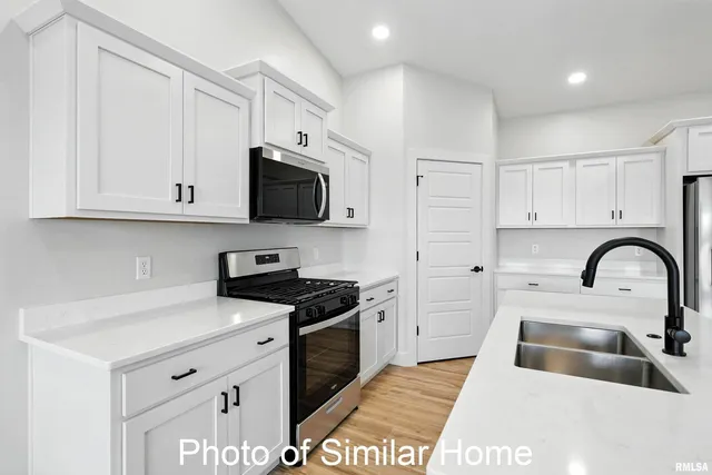 a kitchen with a sink stainless steel appliances and cabinets
