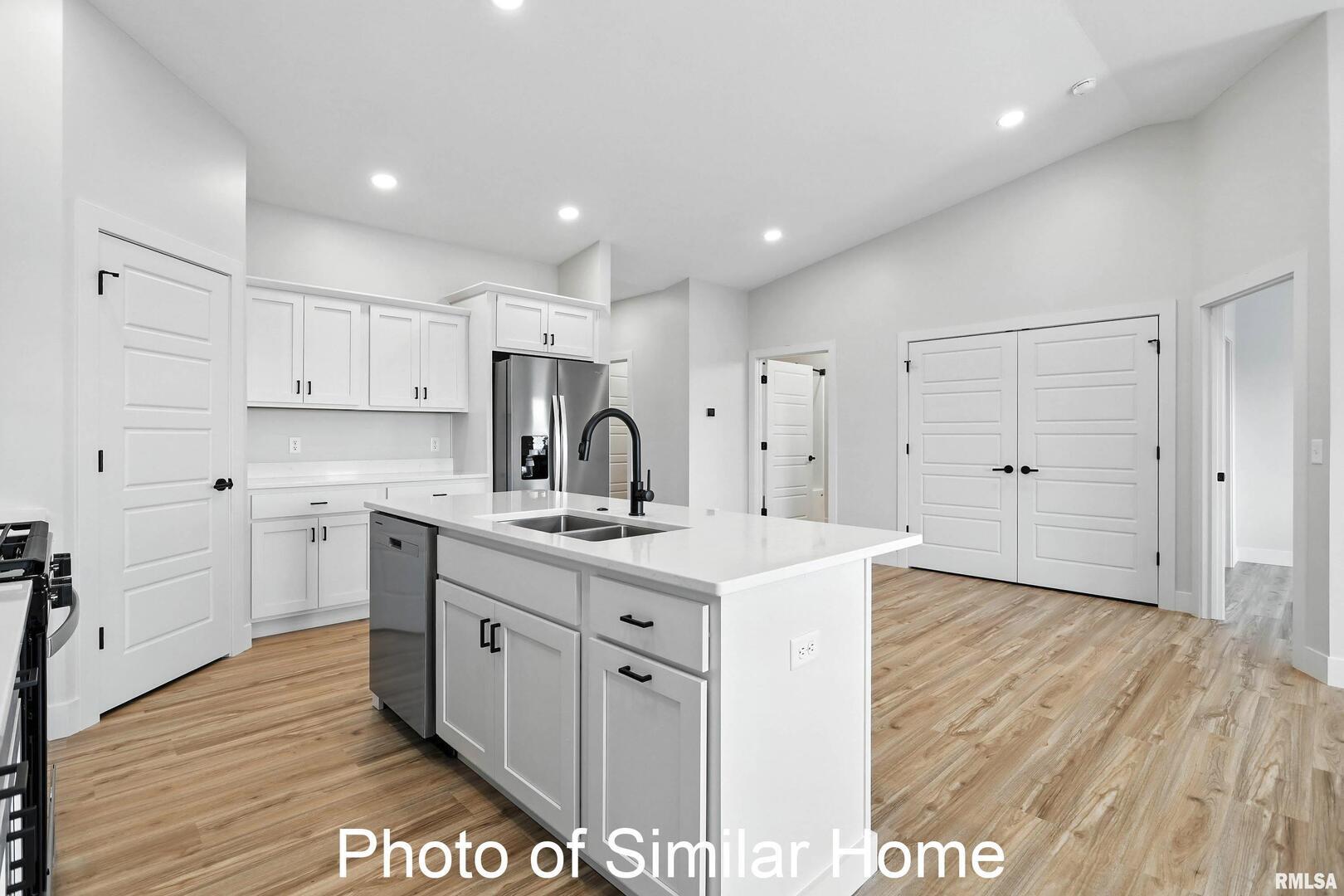 559 North 4th Avenue Eldridge, IA 52748 - Photo 15 of 31 a kitchen with a sink stainless steel appliances and cabinets