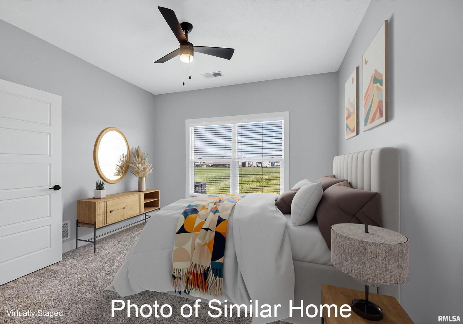 559 North 4th Avenue Eldridge, IA 52748 - Photo 21 of 31 a bed room with a bed mirror and a window