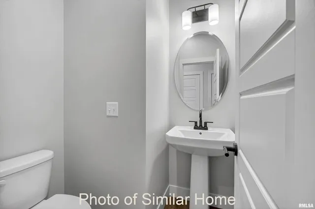 a bathroom with a sink a toilet and mirror