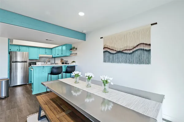 a kitchen with stainless steel appliances a refrigerator and a stove top oven