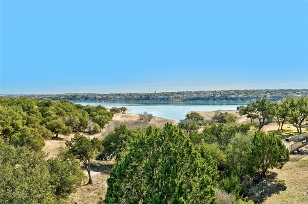 a view of a lake with houses in the back