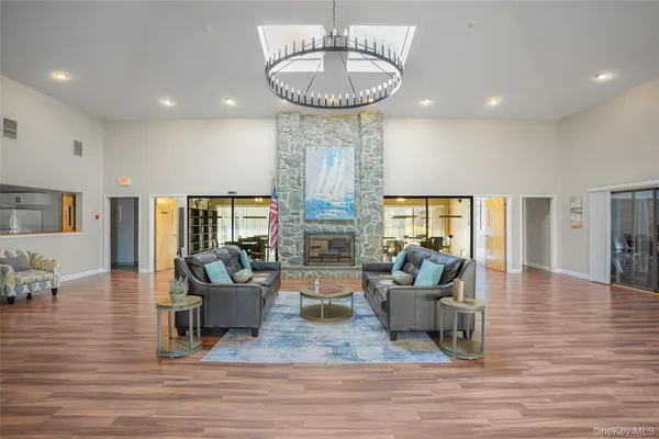 a living room with fireplace furniture and a wooden floor