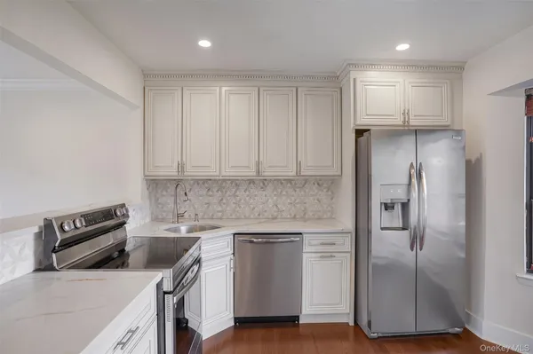 a kitchen with a refrigerator sink and cabinets