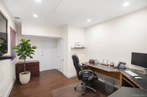 a view of a workspace with furniture and a potted plant