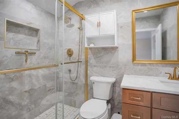 a bathroom with a toilet sink and shower