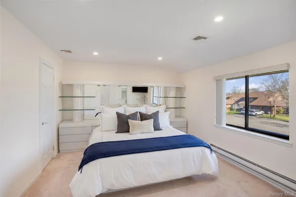 a bedroom with a large bed and a large window