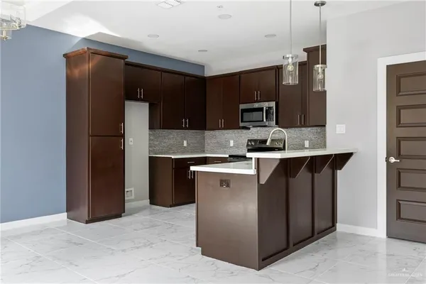 a kitchen with a sink stainless steel appliances and cabinets