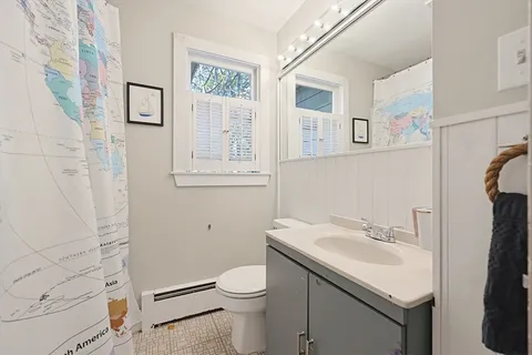a bathroom with a sink a toilet and a mirror