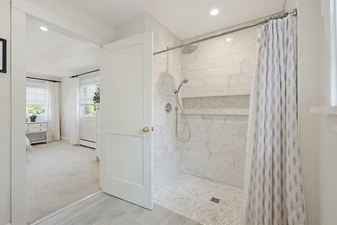 a bathroom with a glass shower door