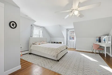 a bedroom with a bed and a table