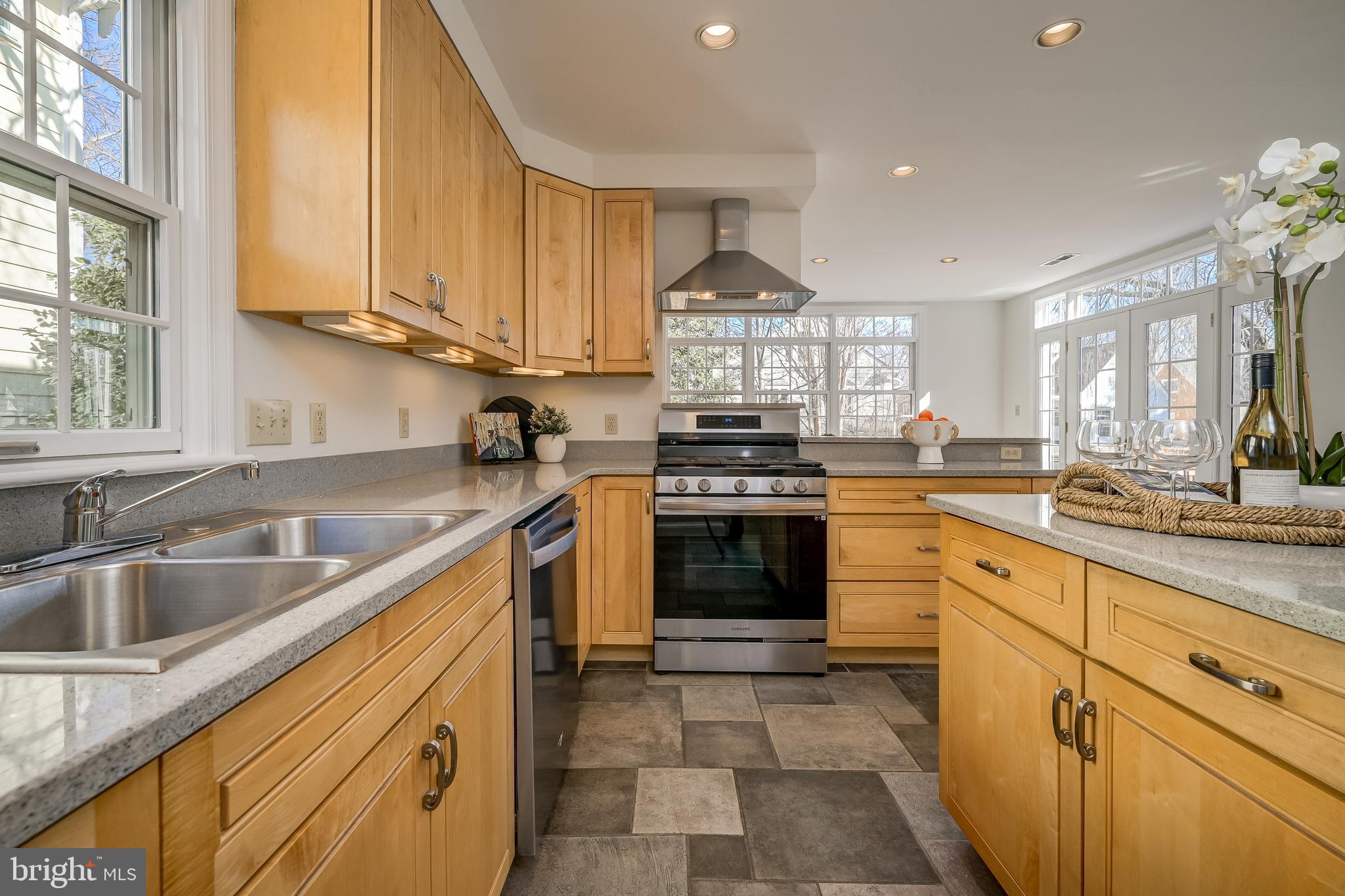 7817 Stratford Road Bethesda, MD 20814 - Photo 13 of 38 a kitchen with stainless steel appliances granite countertop a sink a stove and a wooden floors