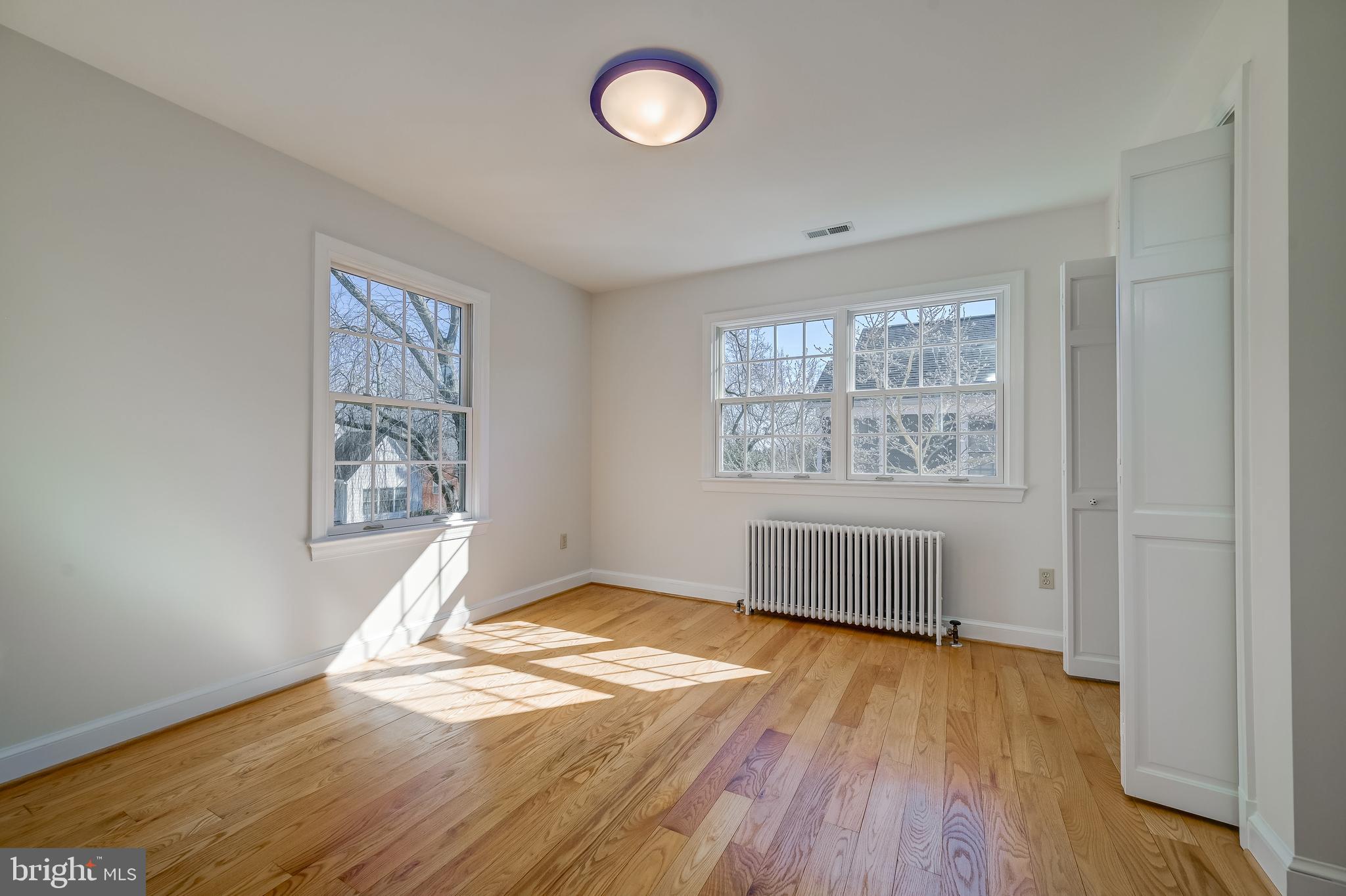 7817 Stratford Road Bethesda, MD 20814 - Photo 25 of 38 an empty room with wooden floor and windows