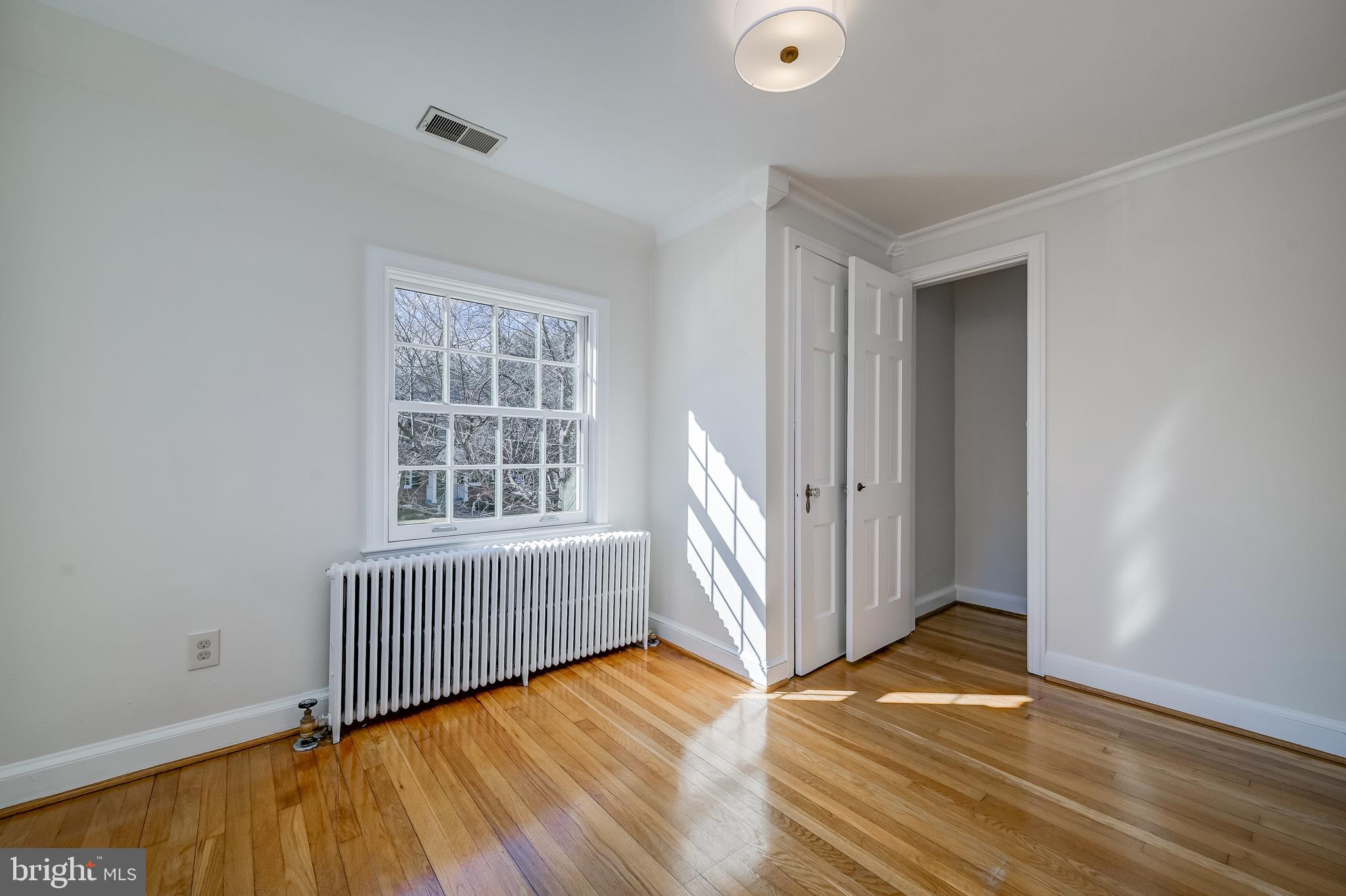 7817 Stratford Road Bethesda, MD 20814 - Photo 28 of 38 an empty room with wooden floor and windows