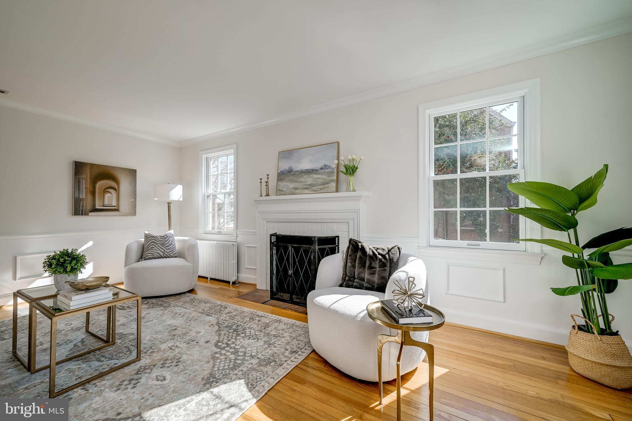 7817 Stratford Road Bethesda, MD 20814 - Photo 6 of 38 a living room with furniture a potted plant and a fireplace