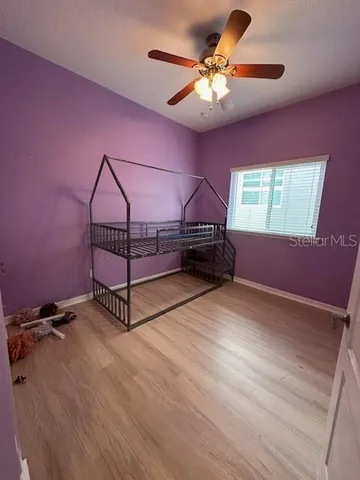 a view of a livingroom with a ceiling fan and window