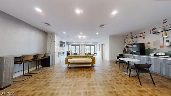 a living room with furniture floor to ceiling window and wooden floor
