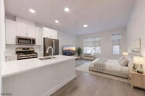 a kitchen with a refrigerator and a stove top oven