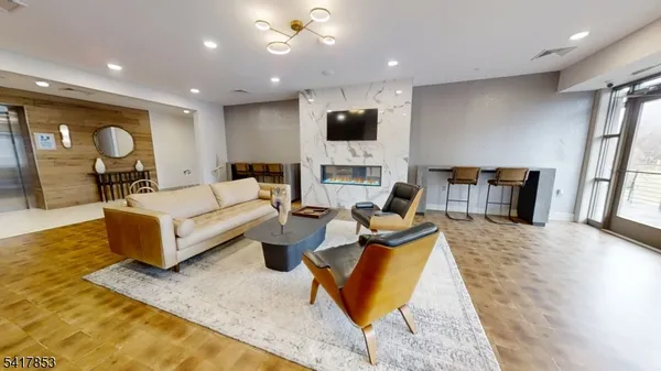 a living room with fireplace furniture and a flat screen tv