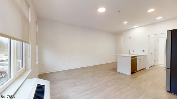 a kitchen with a sink appliances and cabinets