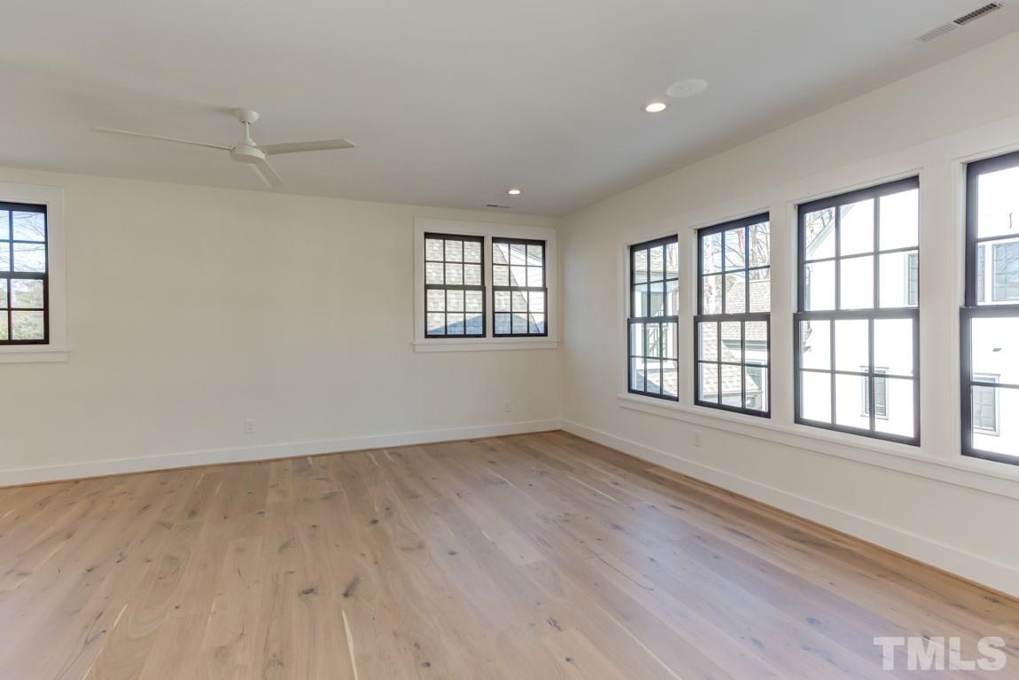 612 Shelley Road Raleigh, NC 27609 - Photo 11 of 19 an empty room with wooden floor and windows