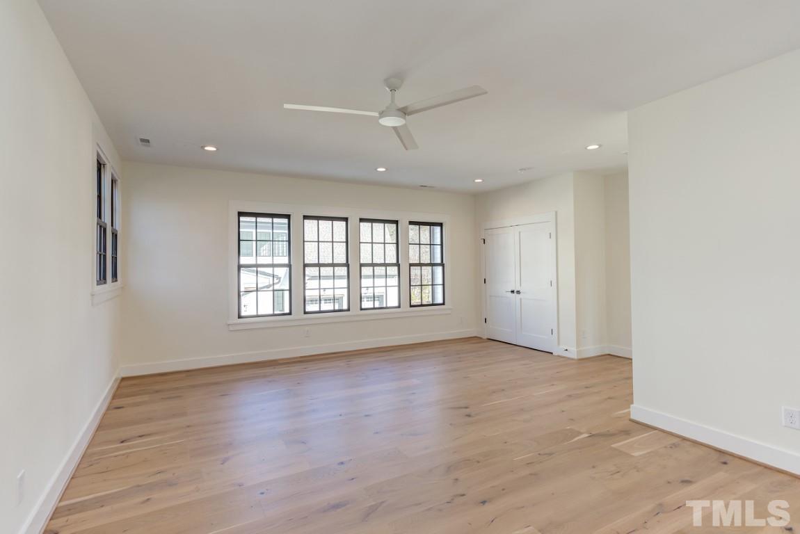 612 Shelley Road Raleigh, NC 27609 - Photo 12 of 19 an empty room with wooden floor and windows