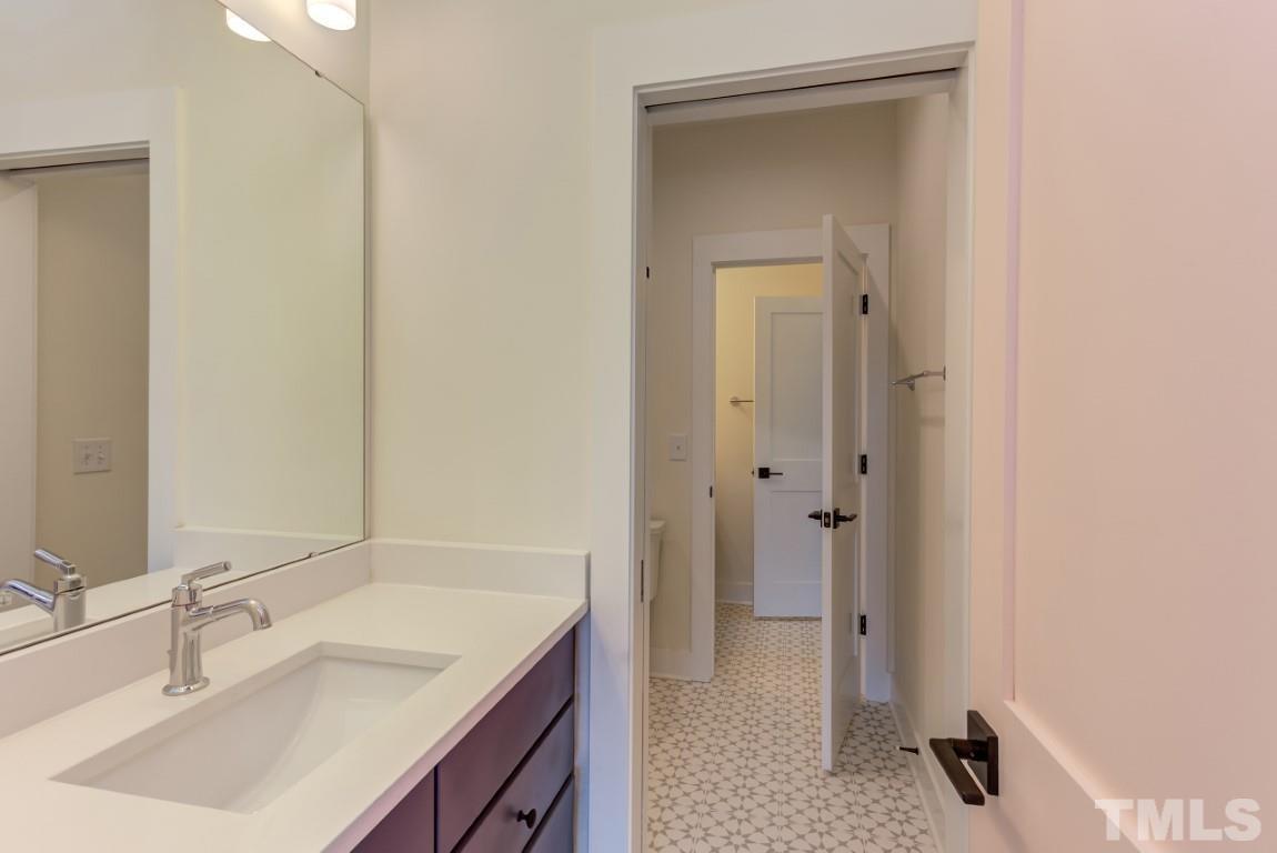 612 Shelley Road Raleigh, NC 27609 - Photo 16 of 19 a bathroom with a sink a vanity and a mirror