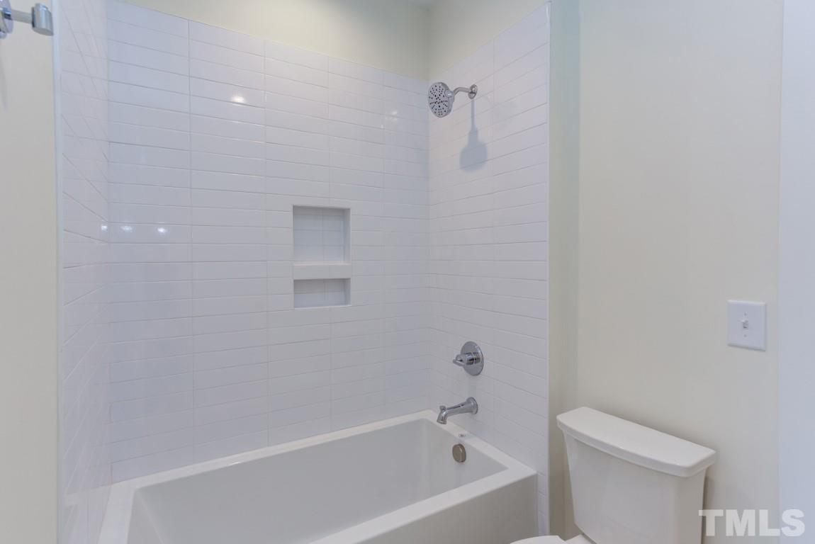 612 Shelley Road Raleigh, NC 27609 - Photo 17 of 19 a white bath tub sitting next to a white toilet