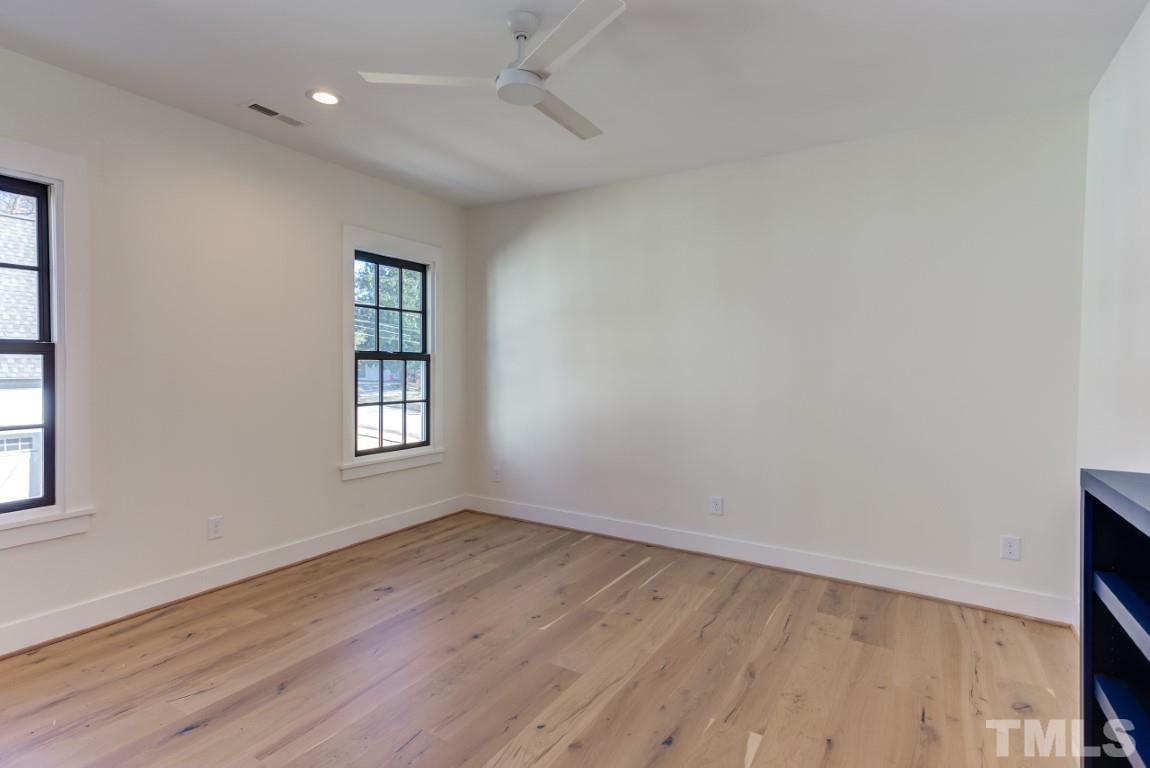 612 Shelley Road Raleigh, NC 27609 - Photo 19 of 19 an empty room with wooden floor and windows