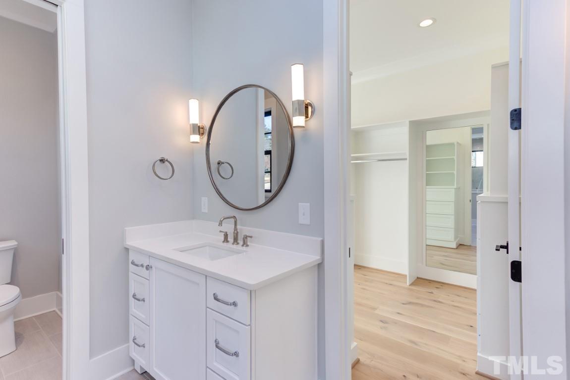 612 Shelley Road Raleigh, NC 27609 - Photo 6 of 19 a bathroom with a sink and a mirror